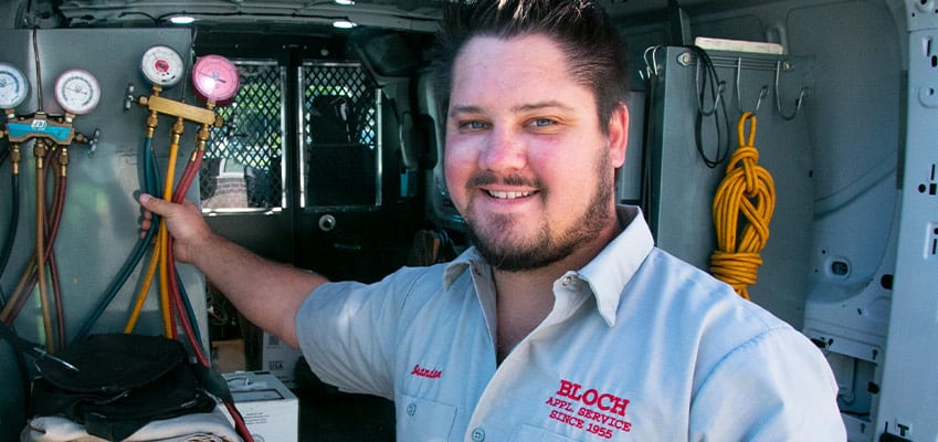 Bloch-AC-Repair-01 HVAC technician repairing an air condiontioner unit