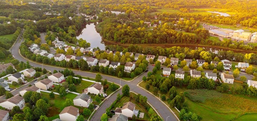 Aerial view of residential suburban neighborhood at early sunrise.